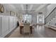 Bright dining room has modern decor, coffered ceiling and a large picture window for plenty of natural light at 4575 Birch Way, Loganville, GA 30052