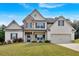 Charming two-story home with painted brick, stone accents, manicured lawn and front porch at 4575 Birch Way, Loganville, GA 30052