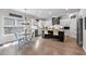 Open kitchen boasts granite countertops, stainless appliances, breakfast bar and adjacent eat-in area with bright light at 4575 Birch Way, Loganville, GA 30052