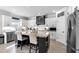 Spacious kitchen features granite countertops, stainless appliances, large island with bar seating and natural lighting at 4575 Birch Way, Loganville, GA 30052