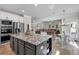 Spacious kitchen has a granite island with breakfast bar and opens into the living room for easy entertaining at 4575 Birch Way, Loganville, GA 30052