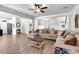 Open-concept living room featuring hardwood floors, and a large sofa at 4575 Birch Way, Loganville, GA 30052