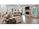 Comfortable living room with a brick fireplace, ample seating and hardwood floors at 4575 Birch Way, Loganville, GA 30052