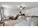 Spacious living room with ample seating, natural light, and a ceiling fan at 4575 Birch Way, Loganville, GA 30052