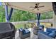 Covered patio with comfortable seating, a fire pit, and an outdoor grill for entertaining at 4575 Birch Way, Loganville, GA 30052