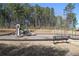 Neighborhood playground with slides and swings, a bench in front, and surrounded by grass and trees at 4575 Birch Way, Loganville, GA 30052