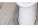 White toilet featuring gray ceramic tile flooring at 4575 Birch Way, Loganville, GA 30052