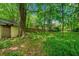 Shaded backyard features a shed, lush green foliage, and privacy at 957 Harwell Nw St, Atlanta, GA 30314