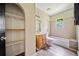 Bathroom with shelves, single sink vanity, toilet, and tub/shower at 957 Harwell Nw St, Atlanta, GA 30314