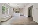 Open-concept dining area featuring updated flooring, window, and open access to other rooms at 957 Harwell Nw St, Atlanta, GA 30314