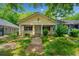 Charming single-story home featuring a covered front porch, light yellow siding and mature trees at 957 Harwell Nw St, Atlanta, GA 30314