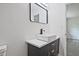 Stylish bathroom with a rectangular mirror, modern vanity, and a view into the walk-in shower at 4701 Flat Shoals Rd # 35E, Union City, GA 30291