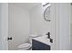 Contemporary half bathroom featuring sleek fixtures, a round mirror, and modern vanity at 4701 Flat Shoals Rd # 35E, Union City, GA 30291