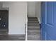 Welcoming entryway featuring carpeted stairs, with hardwood floors and modern accent wall at 4701 Flat Shoals Rd # 35E, Union City, GA 30291