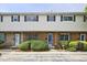 Charming townhome featuring a brick facade, white siding, and well-maintained landscaping at 4701 Flat Shoals Rd # 35E, Union City, GA 30291