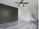 Bright living room with new hardwood floors, ceiling fan, and gray accent wall at 4701 Flat Shoals Rd # 35E, Union City, GA 30291
