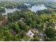 Aerial view of a neighborhood on a lake, showing home and surrounding trees and a pool at 522 Knollwood Dr, Stockbridge, GA 30281