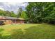 Spacious backyard with mature trees, solar panels, and outdoor seating at 522 Knollwood Dr, Stockbridge, GA 30281