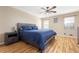 Bedroom with hardwood flooring, ceiling fan, and natural light from two windows at 522 Knollwood Dr, Stockbridge, GA 30281