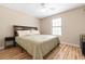 Bedroom with wood flooring, ceiling fan, and a bedside table at 522 Knollwood Dr, Stockbridge, GA 30281