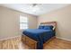 Bedroom with wood floors, ceiling fan, and storage drawers under the bed at 522 Knollwood Dr, Stockbridge, GA 30281