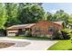 Charming wood and stone home featuring an attached garage, well-manicured lawn and a driveway at 522 Knollwood Dr, Stockbridge, GA 30281