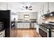 Bright kitchen with stainless steel appliances and white cabinets at 522 Knollwood Dr, Stockbridge, GA 30281