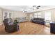 Open-concept living room features hardwood floors, ceiling fans, and neutral paint at 522 Knollwood Dr, Stockbridge, GA 30281