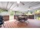 Screened patio with wood decking and a dining table set for outdoor living at 522 Knollwood Dr, Stockbridge, GA 30281