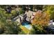 Aerial view of an estate featuring an inground pool surrounded by mature trees at 2515 Habersham Rd, Atlanta, GA 30305