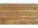 Close up on elegant, sleek gold drawer pulls on wood kitchen cabinets at 2515 Habersham Rd, Atlanta, GA 30305