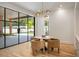 Chic dining area with views of pool with backyard access through black framed glass doors at 2515 Habersham Rd, Atlanta, GA 30305