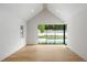 Bright, spacious room with modern hardwood floors and a large window with pool view offers versatility and comfort at 2515 Habersham Rd, Atlanta, GA 30305