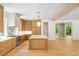 Well-lit kitchen showcases an island, marble backsplash, and stainless steel appliances with hardwood flooring at 2515 Habersham Rd, Atlanta, GA 30305