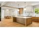 Bright, open kitchen with a large island, marble countertops, wood cabinets and high end appliances at 2515 Habersham Rd, Atlanta, GA 30305