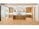 Bright kitchen boasts a large island, marble countertops, wooden cabinets and modern pendant lighting at 2515 Habersham Rd, Atlanta, GA 30305