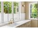Well-lit kitchen sink with stainless fixtures looks out onto mature trees at 2515 Habersham Rd, Atlanta, GA 30305