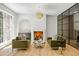Cozy living room with fireplace, stylish light fixture, wet bar and views to a glass-enclosed area at 2515 Habersham Rd, Atlanta, GA 30305