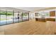 Open-concept living space with hardwood floors, leading to kitchen and outdoor patio through steel doors at 2515 Habersham Rd, Atlanta, GA 30305