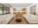 Open-concept living space with hardwood floors, seamlessly connecting the kitchen and dining areas at 2515 Habersham Rd, Atlanta, GA 30305