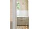 Charming wet bar with shaker cabinets, a marble countertop and a wall light is showcased in the arched nook at 2515 Habersham Rd, Atlanta, GA 30305