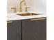 This wet bar features shaker cabinets, marble countertops, a tiled backsplash, and contemporary gold fixtures at 2515 Habersham Rd, Atlanta, GA 30305