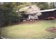 Front view of a log cabin-style home surrounded by trees at 3315 Canterbury Trl, Rex, GA 30273