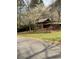 Quaint home with a red door and blooming trees in the front yard at 3315 Canterbury Trl, Rex, GA 30273