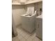 Bright laundry room with white appliances and tiled floor at 3315 Canterbury Trl, Rex, GA 30273