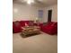 Cozy living room showcasing a red sofa set, neutral carpet, and a stylish coffee table at 3315 Canterbury Trl, Rex, GA 30273