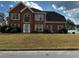 Charming two-story brick home with a well-manicured front yard and traditional architectural details at 500 Kings Pl, Riverdale, GA 30296