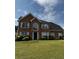 Charming brick home featuring a well-manicured lawn and symmetrical window placements at 500 Kings Pl, Riverdale, GA 30296