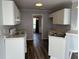 Kitchen with white cabinets, luxury vinyl plank flooring, and neutral walls at 500 Kings Pl, Riverdale, GA 30296