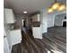 Open-concept kitchen with modern appliances and breakfast bar seamlessly flows into the living area at 500 Kings Pl, Riverdale, GA 30296